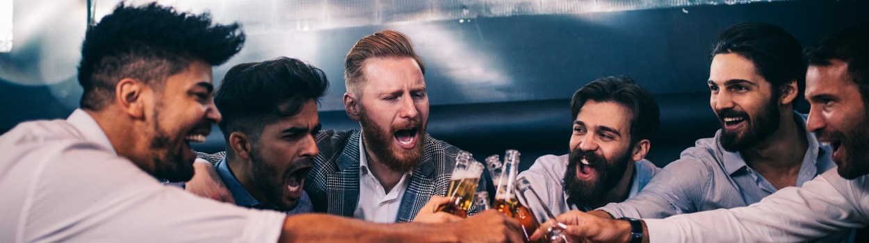 A group of men toasting beers